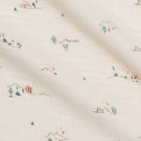 Close-up of the tiny cactus and mountain print on the Colored Organics Organic Muslin Swaddle Blanket in Desert