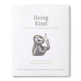 Compendium Being Kind book, white cover with a gray sloth illustration and gold sunburst lines