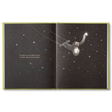 Compendium Being Kind book open to a sloth reaching for a star in a black night sky