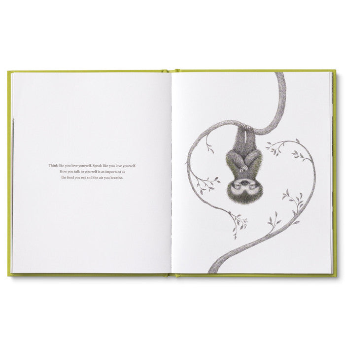 Compendium Being Kind book open to two sloths hanging from vines in a heart shape