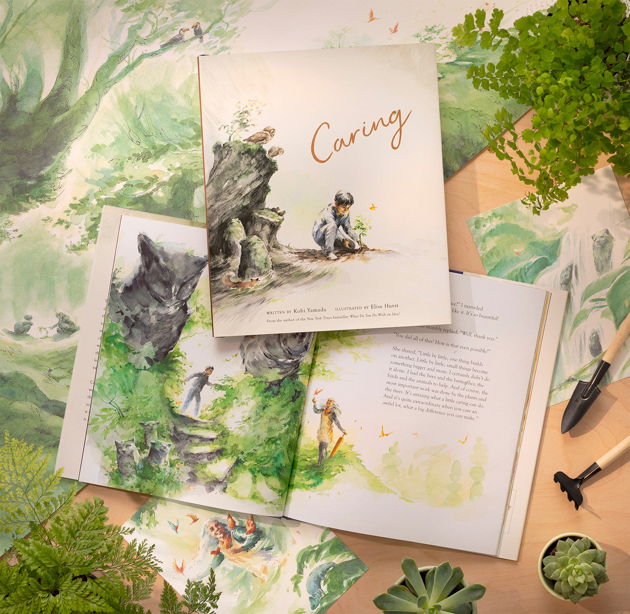 Compendium Caring book open with a second copy on top, surrounded by leaves and gardening items