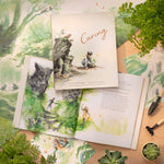 Compendium Caring book open with a second copy on top, surrounded by leaves and gardening items