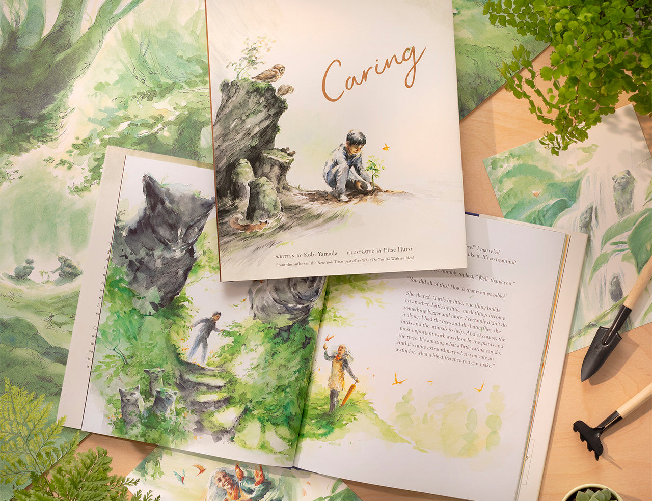 Compendium Caring book open with a second copy on top, surrounded by leaves and gardening items