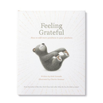 Compendium Feeling Grateful book cover with a gray bear lying on its back on a white sunburst background
