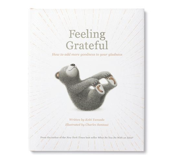 Compendium Feeling Grateful book cover with a gray bear lying on its back on a white sunburst background