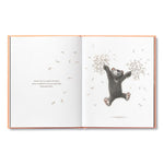 Compendium Feeling Grateful book open to an illustration of a bear holding a tree branch with falling leaves
