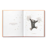 Compendium Feeling Grateful book open to an illustration of a bear holding a tree branch with falling leaves