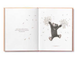 Compendium Feeling Grateful book open to an illustration of a bear holding a tree branch with falling leaves