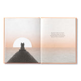 Compendium Feeling Grateful book open to a bear watching a sunset over water