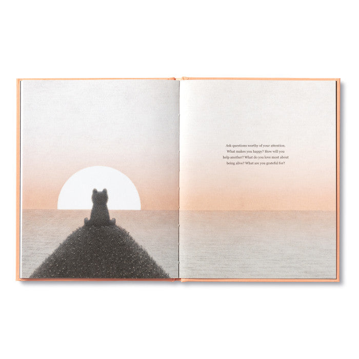 Compendium Feeling Grateful book open to a bear watching a sunset over water