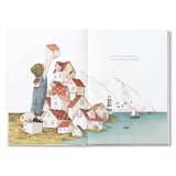 Compendium Maybe Deluxe Book open to a child building a stack of tiny houses