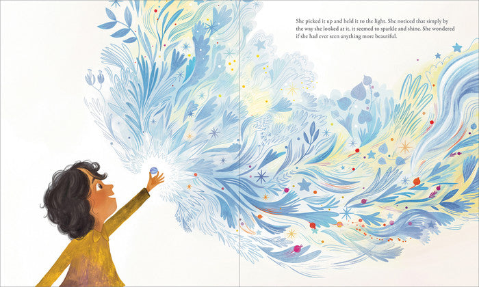 Compendium The Candy Dish book open to a child gazing at swirling blue feathers and stars