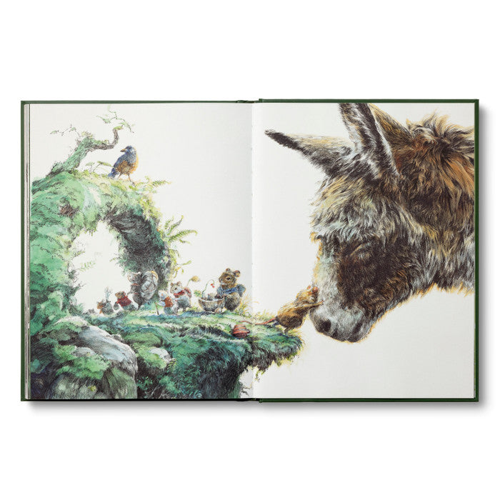 Compendium The Storyteller's Almanac open to a watercolor of a donkey meeting tiny characters on a mossy hill