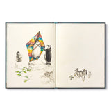 Compendium The Storyteller's Handbook open to a watercolor of penguins flying a colorful kite