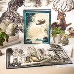 Compendium The Storyteller's Handbook displayed with open pages, a deer figurine and plants