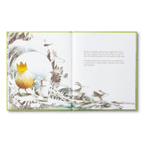Compendium What Do You Do With an Idea book open to a child standing with the golden egg among birds