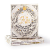 Compendium What You Do Matters boxed set, a cream slipcase with a gold wreath standing on the three books