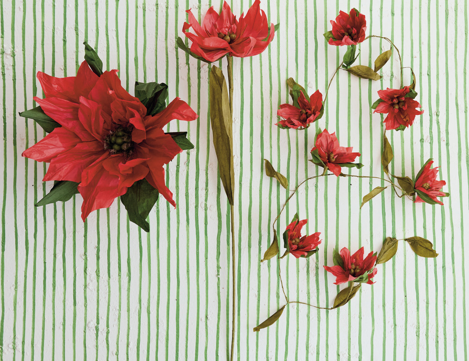 Paper poinsettia garland styled on a table