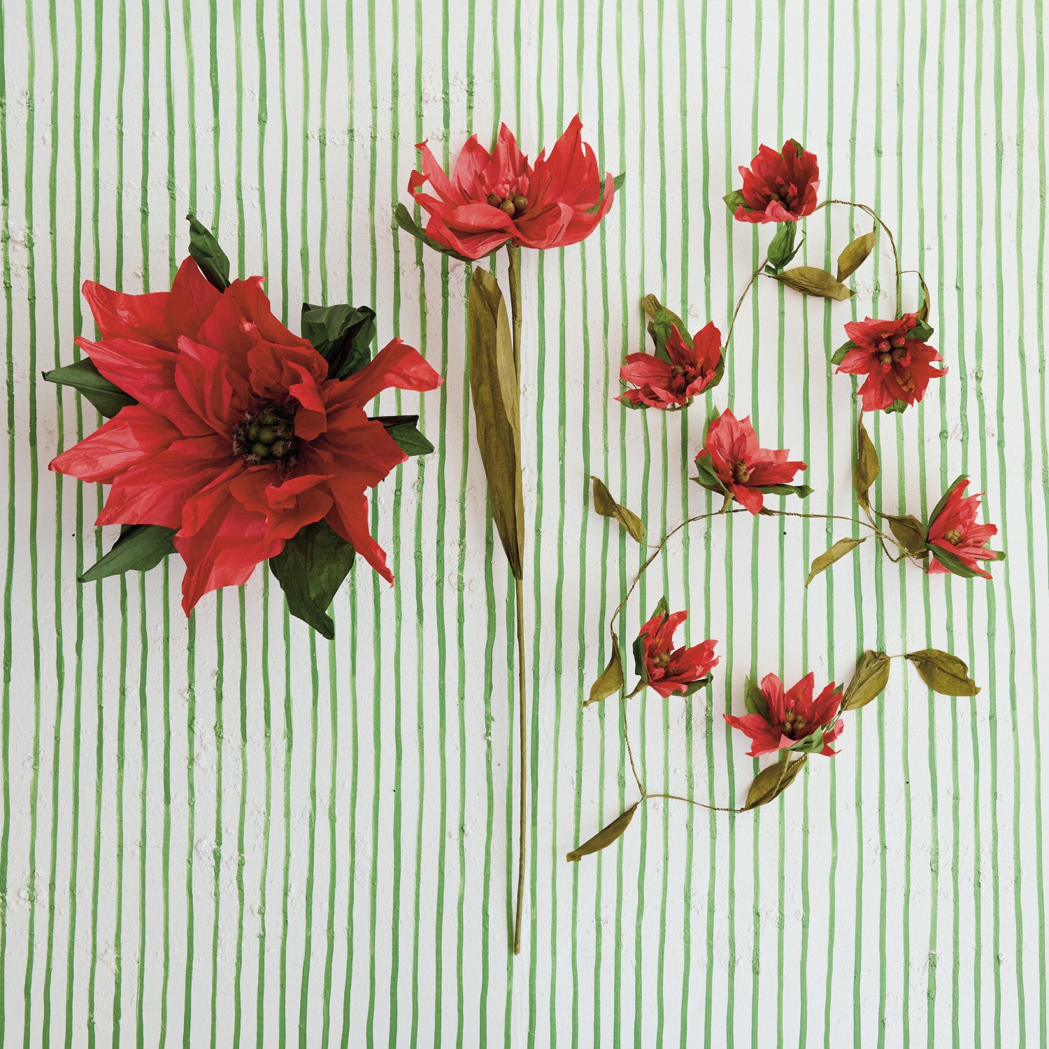 Paper poinsettia garland styled on a table
