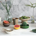 Creative Co-Op Stoneware Cactus Juicer on a kitchen counter with grapefruit halves and a bowl of limes