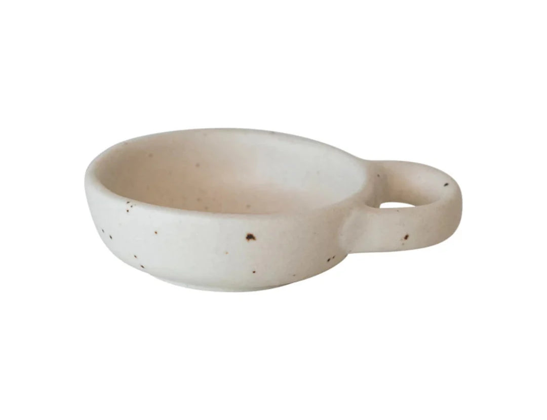 Creative Co-Op Stoneware Dish with Handle, a small speckled cream dish with a loop handle