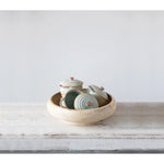 Creative Co-Op Stoneware Mini Bakers stacked inside a larger bowl on a rustic table