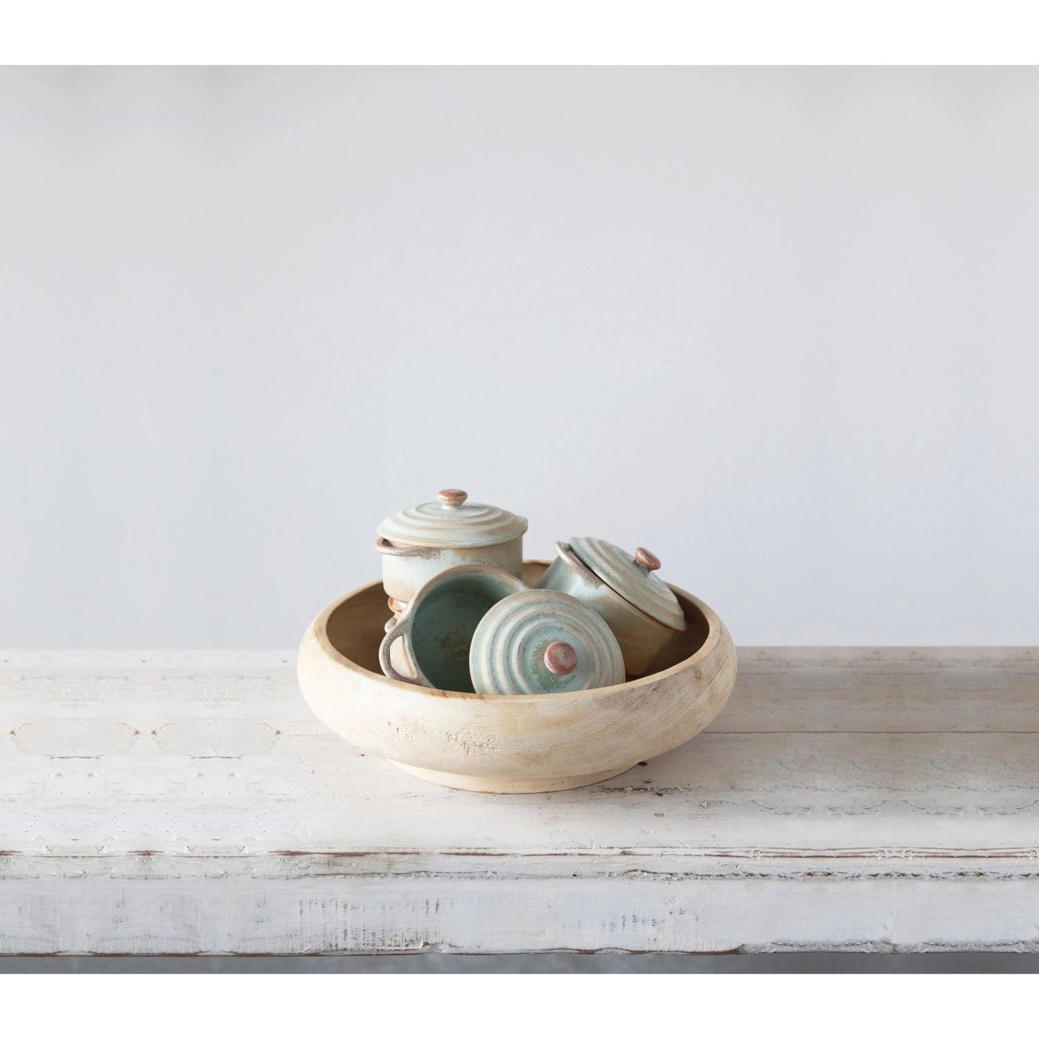 Creative Co-Op Stoneware Mini Bakers stacked inside a larger bowl on a rustic table