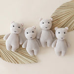 Cuddle & Kind Baby Hippo knit dolls, four cream hippos arranged with dried palm leaves