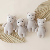 Cuddle & Kind Baby Hippo knit dolls, four cream hippos arranged with dried palm leaves
