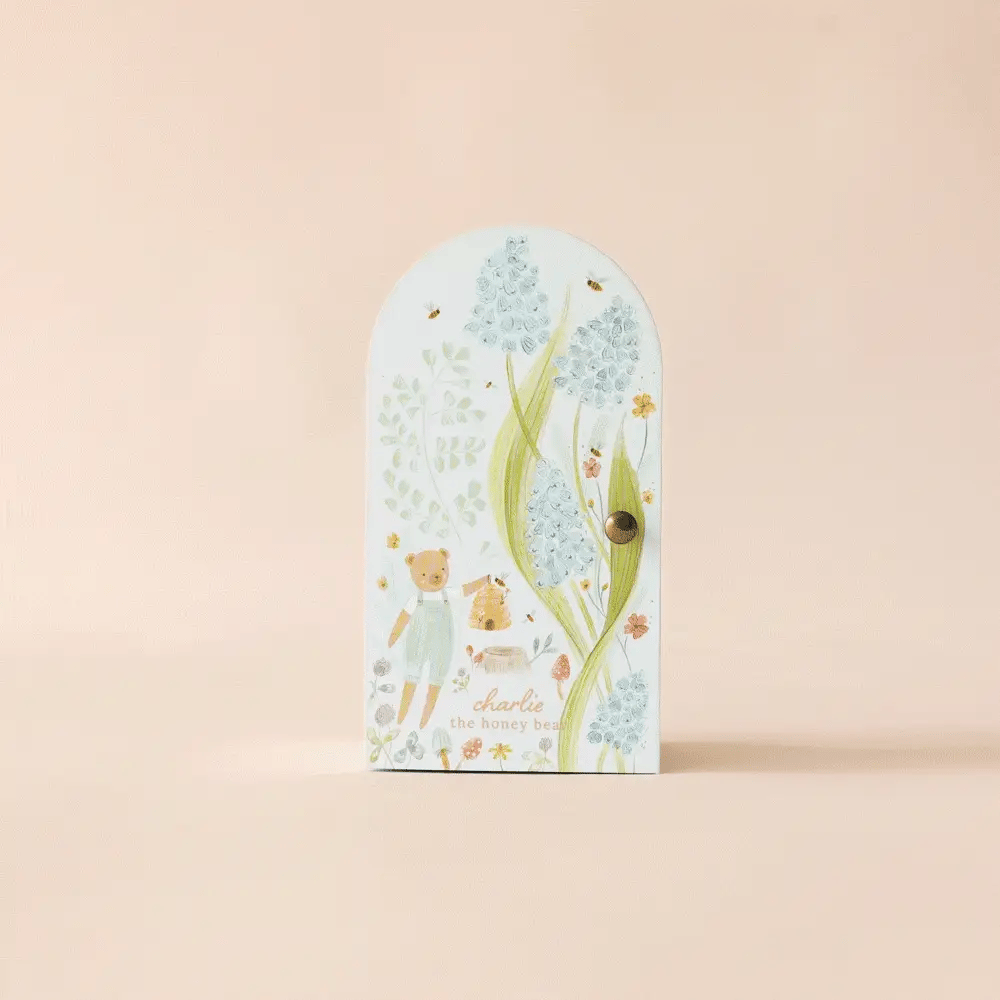 Cuddle + Kind Tiny Charlie the Honey Bear floral arch gift box, closed