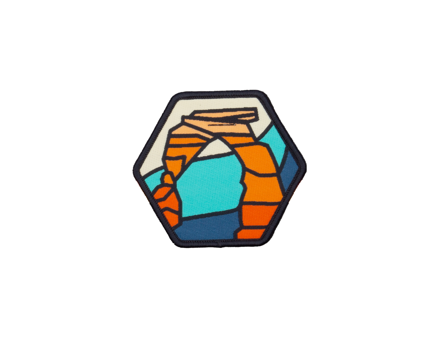 Delicate Arch woven patch, a hexagon showing the arch in orange, teal, cream and navy with a navy merrowed border.