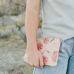 Model holding the Desert Sol Floral Gesture hardcover notebook in Brushed Sand Floral