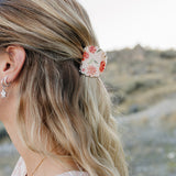 Close up of the Desert Sol Petal Claw Clip in Brushed Sand Floral holding a half up hairstyle
