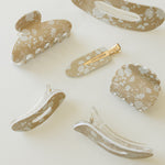 Desert Sol Canyon Rose acrylic hair clip set with an oval lay flat claw clip, classic claw clip, petal claw clip and snap clips with a tan and white floral print