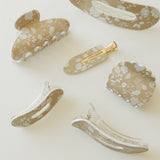 Desert Sol Canyon Rose acrylic hair clip set with an oval lay flat claw clip, classic claw clip, petal claw clip and snap clips with a tan and white floral print