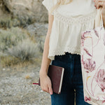 Desert Sol Carryall Tote in Mulberry Floral with the Desert Plum vegan leather journal in hand