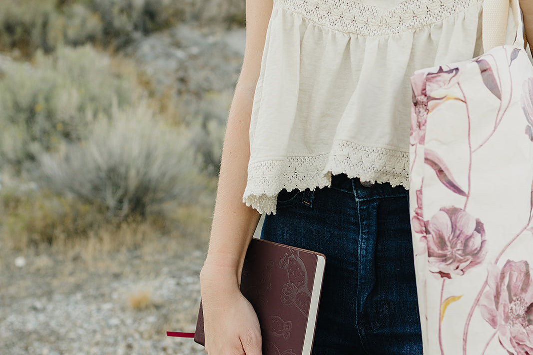 Desert Sol Carryall Tote in Mulberry Floral with the Desert Plum vegan leather journal in hand