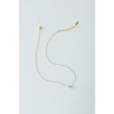 Desert Sol Dune Necklace in gold, a delicate everyday necklace, on a white background