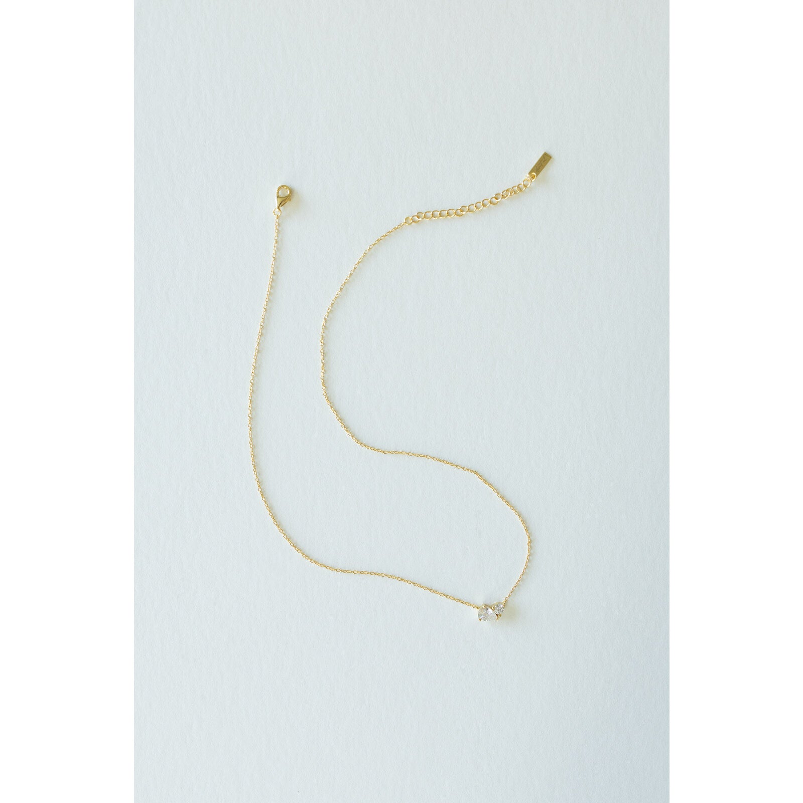 Desert Sol Dune Necklace in gold, a delicate everyday necklace, on a white background