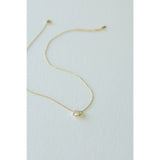 Desert Sol Dune Necklace in gold, a delicate everyday necklace, on a white background