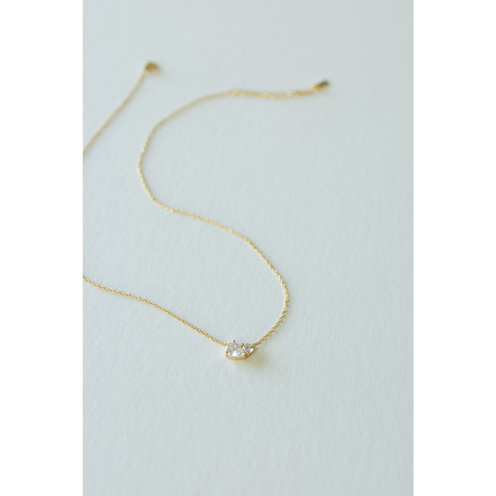 Desert Sol Dune Necklace in gold, a delicate everyday necklace, on a white background