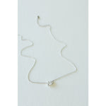 Desert Sol Dune Necklace in silver, a delicate everyday necklace, on a white background