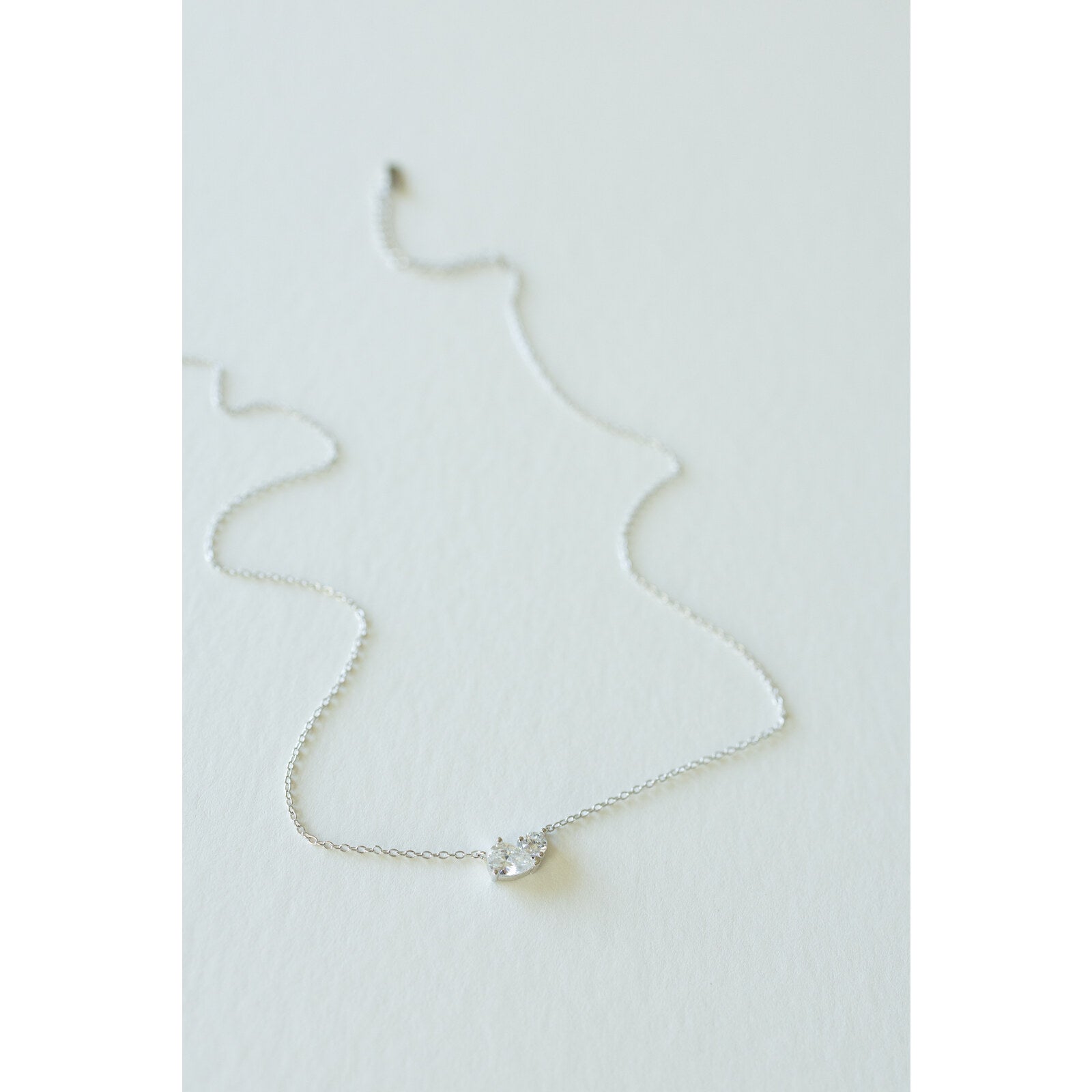 Desert Sol Dune Necklace in silver, a delicate everyday necklace, on a white background