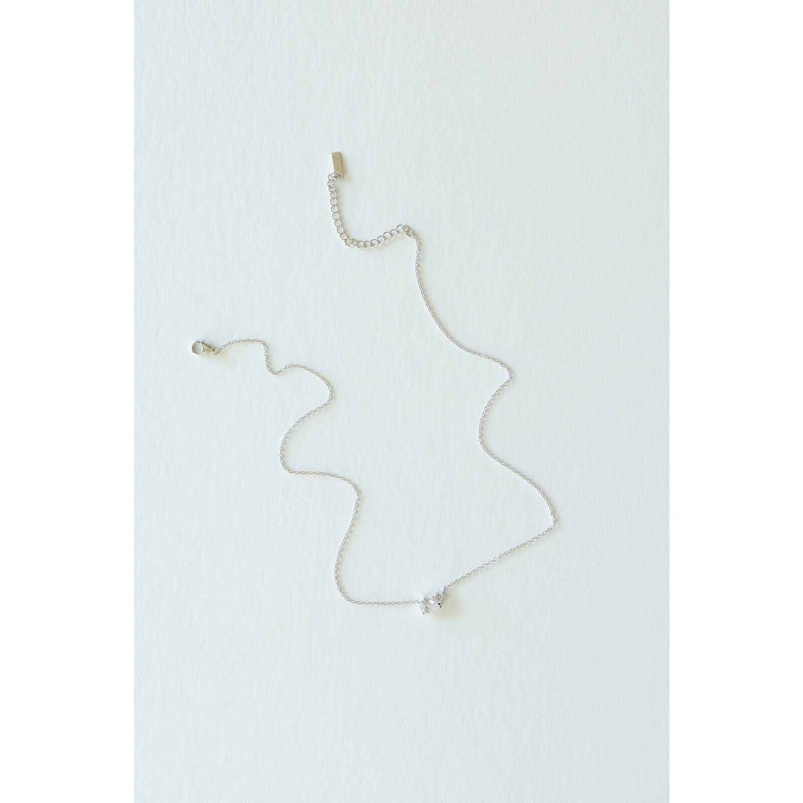 Desert Sol Dune Necklace in silver, a delicate everyday necklace, on a white background