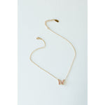 Desert Sol Ember Butterfly Necklace in blush pink, a faceted crystal butterfly pendant on a warm gold chain, on a white background