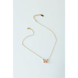 Desert Sol Ember Butterfly Necklace in blush pink, a faceted crystal butterfly pendant on a warm gold chain, on a white background