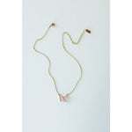 Desert Sol Ember Butterfly Necklace in blush pink, a faceted crystal butterfly pendant on a warm gold chain, on a white background