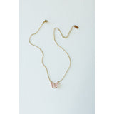 Desert Sol Ember Butterfly Necklace in blush pink, a faceted crystal butterfly pendant on a warm gold chain, on a white background