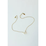 Desert Sol Ember Butterfly Necklace in opal white, a faceted crystal butterfly pendant on a warm gold chain, on a white background