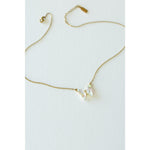 Desert Sol Ember Butterfly Necklace in opal white, a faceted crystal butterfly pendant on a warm gold chain, on a white background
